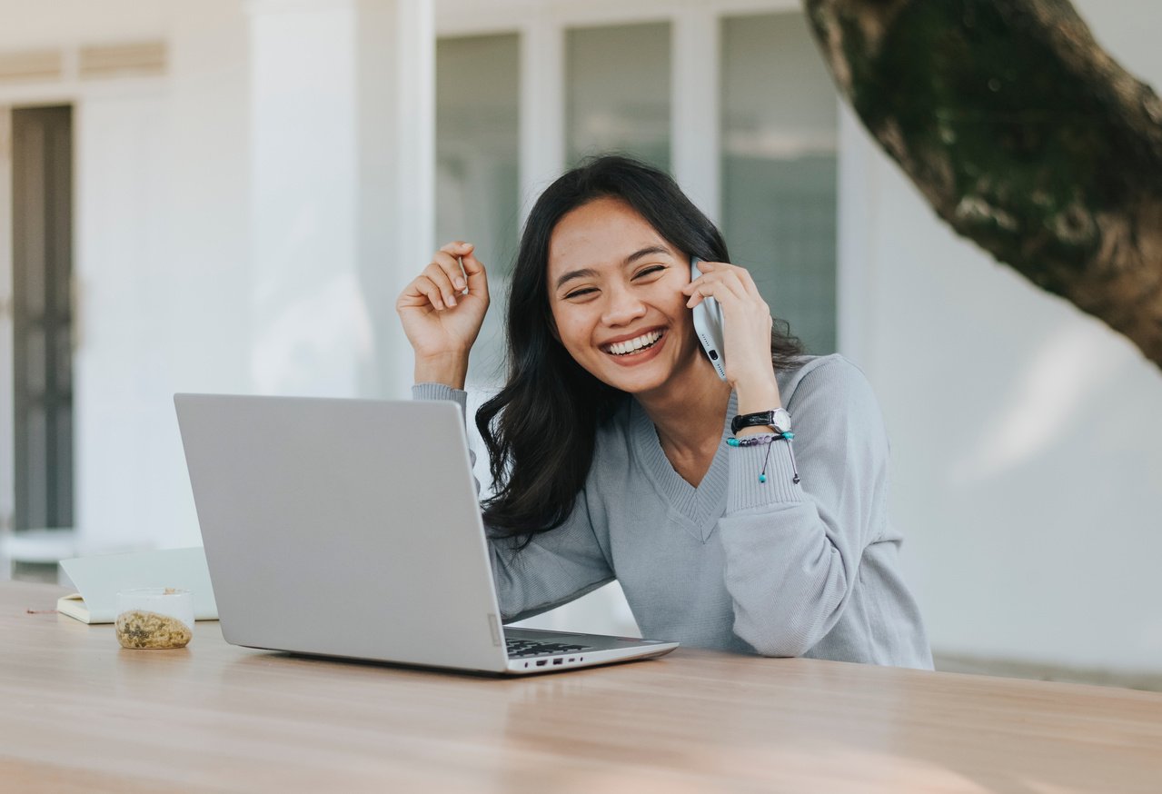 Woman Smiling While on a Phone Call